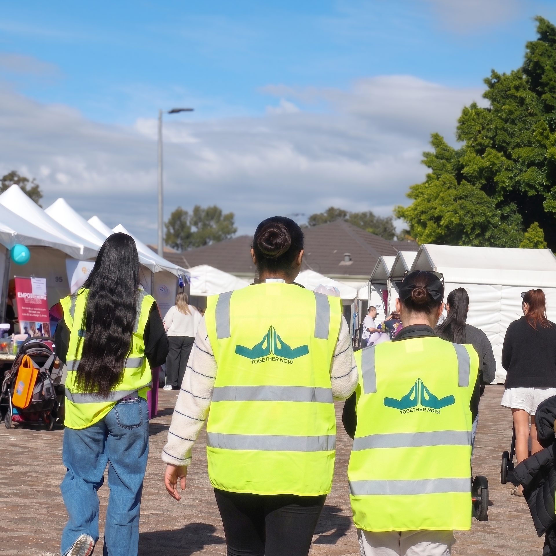 TNWA volunteers walking together at a community event.